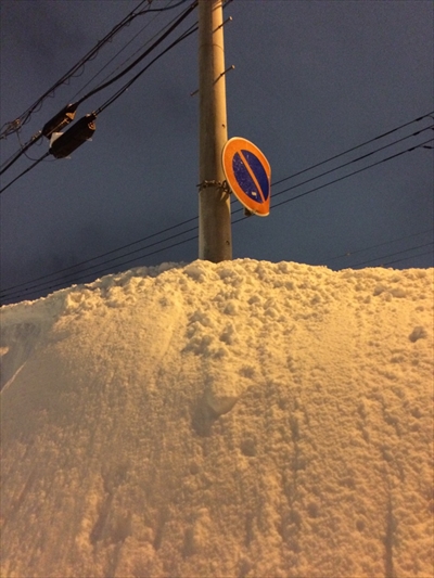 道路標識の埋まっている雪壁